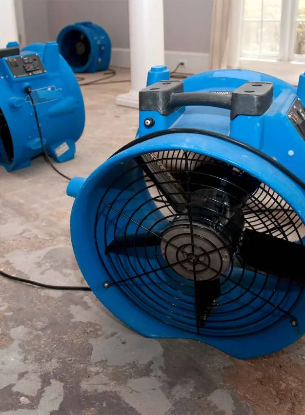 Industrial Fans Drying a Home Damaged by Water