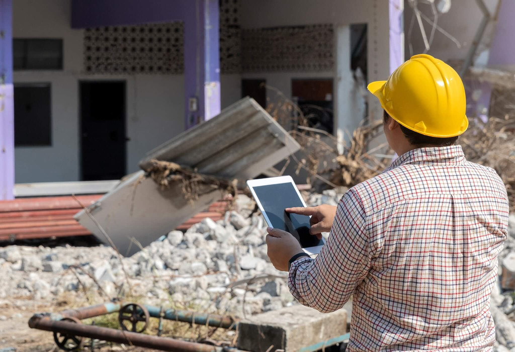 A Male Public Adjuster Inspecting a Collapsed Building